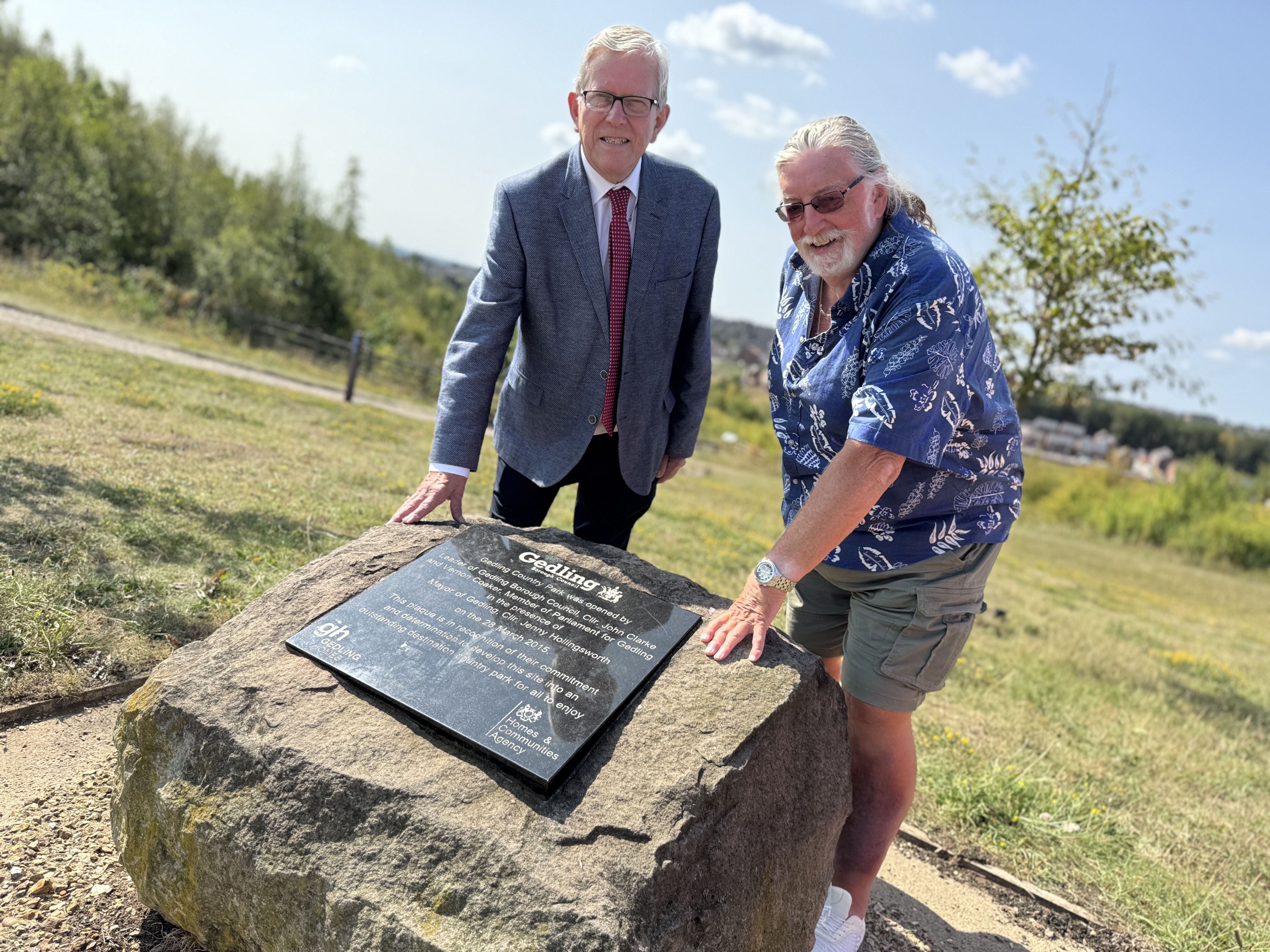 Councillor John Clarke MBE, Leader of Gedling Borough Council with Terry Locke, Chairman of The Friends of Gedling Country Park and staff from Gedling Borough Council at the commemorative stone in Gedling Country Park